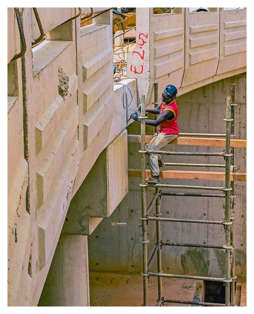 Construction worker in safety gear at a building site in London, illustrating asbestos management and construction safety